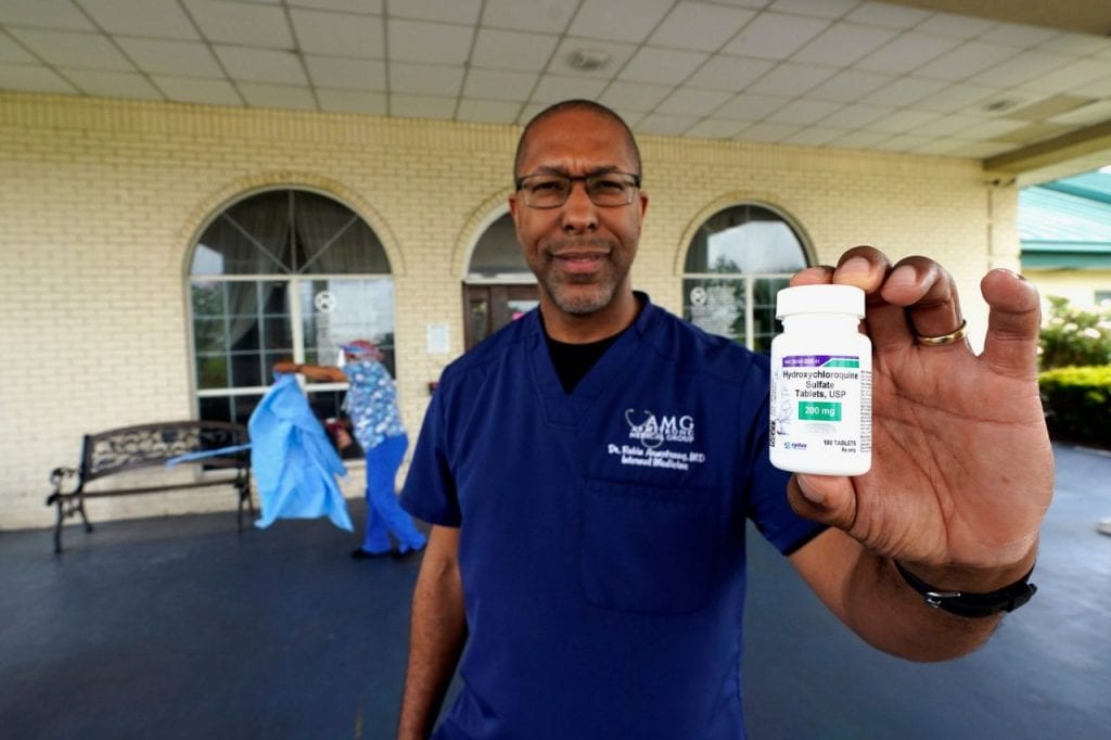 Dr. Robin Armstrong holds a bottle of hydroxychloroquine outside The Resort at Texas City nursing home. (AP Photo/David J. Phillip)