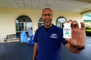 Dr. Robin Armstrong holds a bottle of hydroxychloroquine outside The Resort at Texas City nursing home. (AP Photo/David J. Phillip)